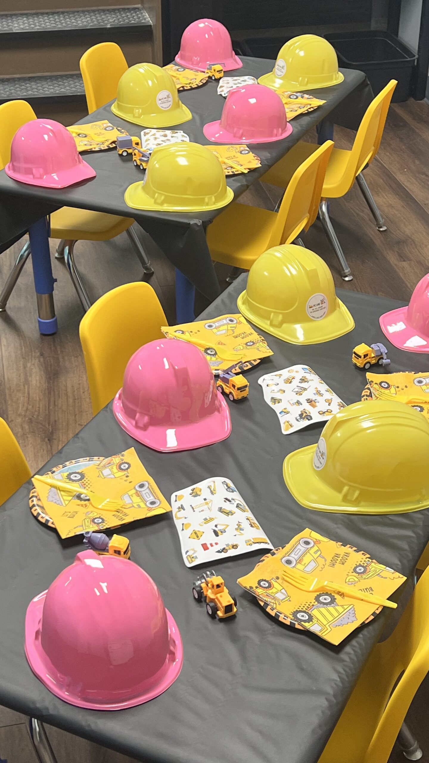 Decorated private party room with balloons, goody bags, and hard hat place settings