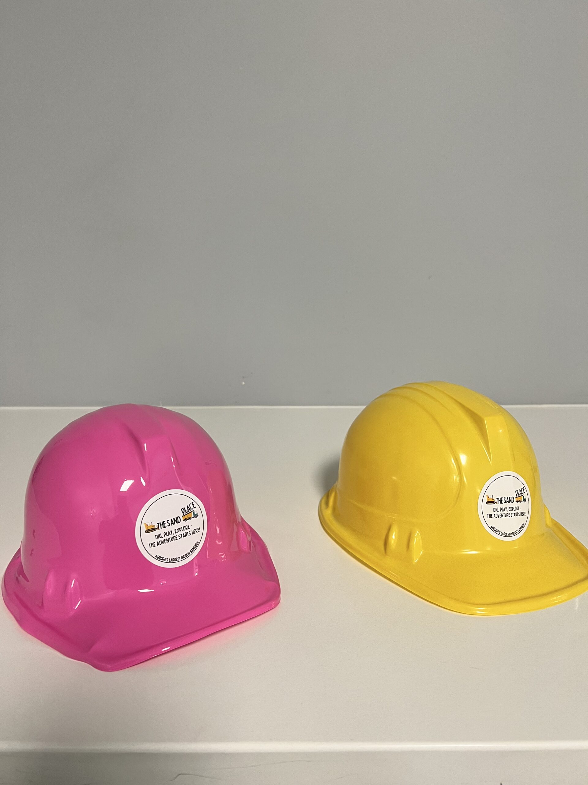 Child pouring sand from bucket at The Sand Place indoor playground Aurora