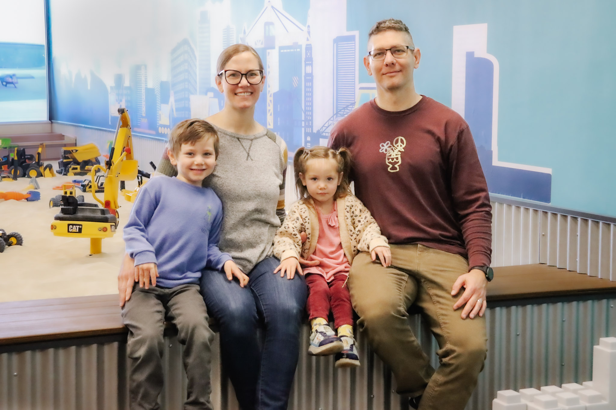 Young children playing in sand at The Sand Place indoor playground near Denver