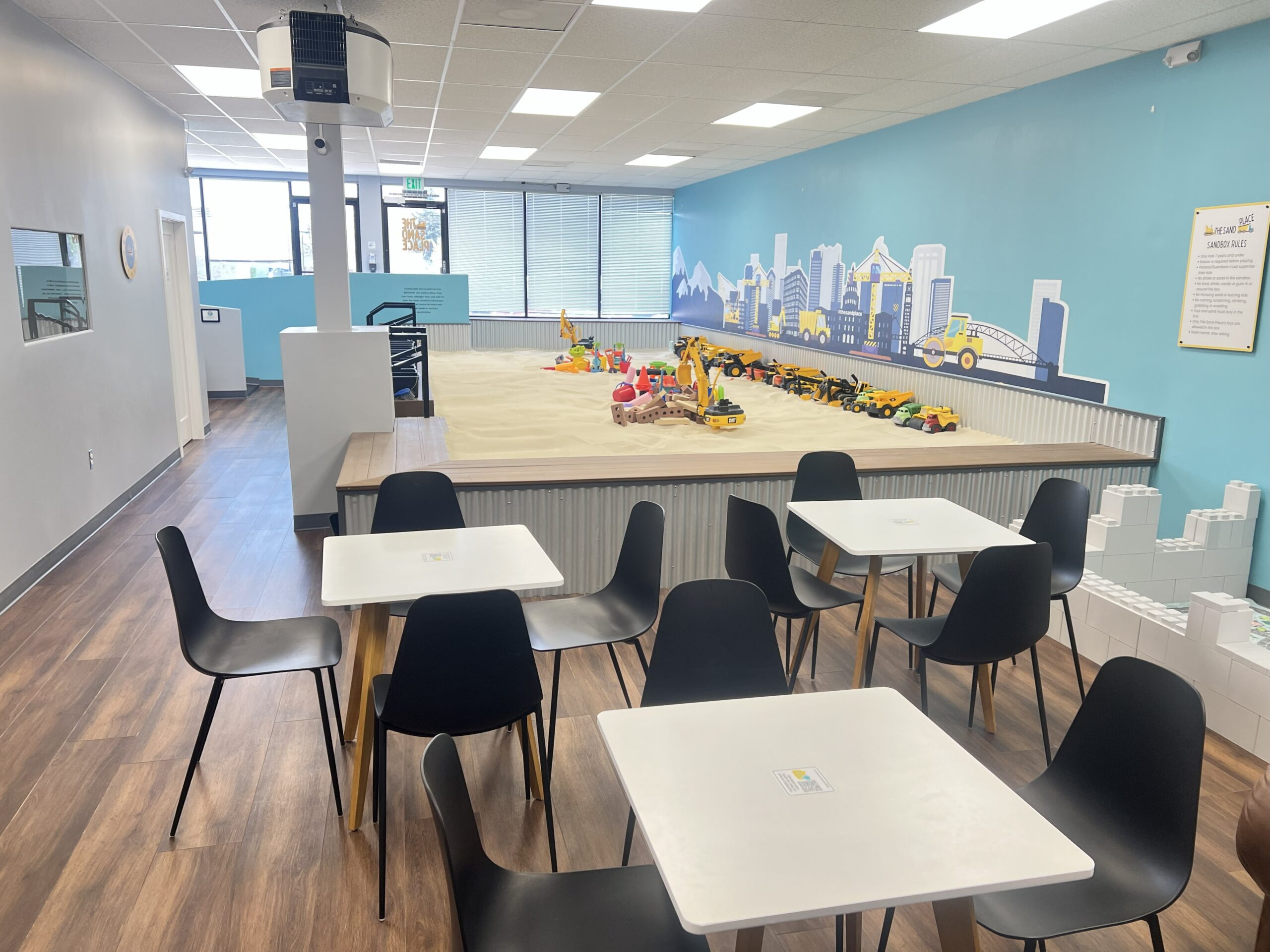 Children digging and building in indoor sandbox at Aurora Colorado playground