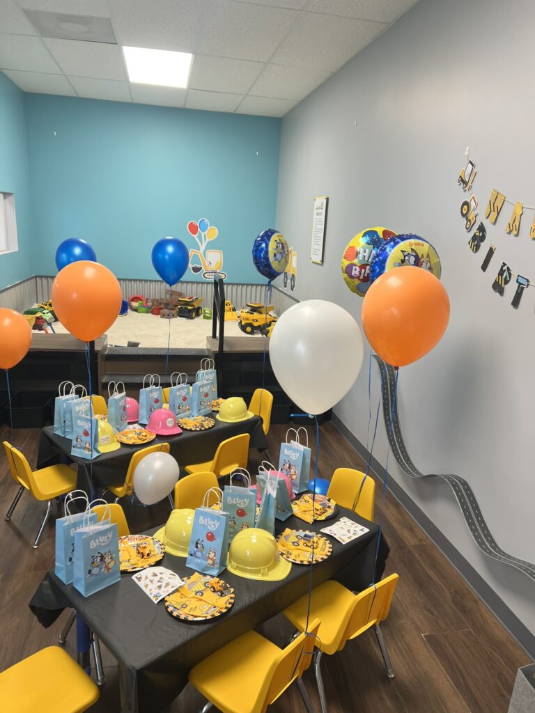 Colorful birthday party room at The Sand Place in Englewood, Colorado, featuring themed decorations, kid-friendly tables, and festive balloons.