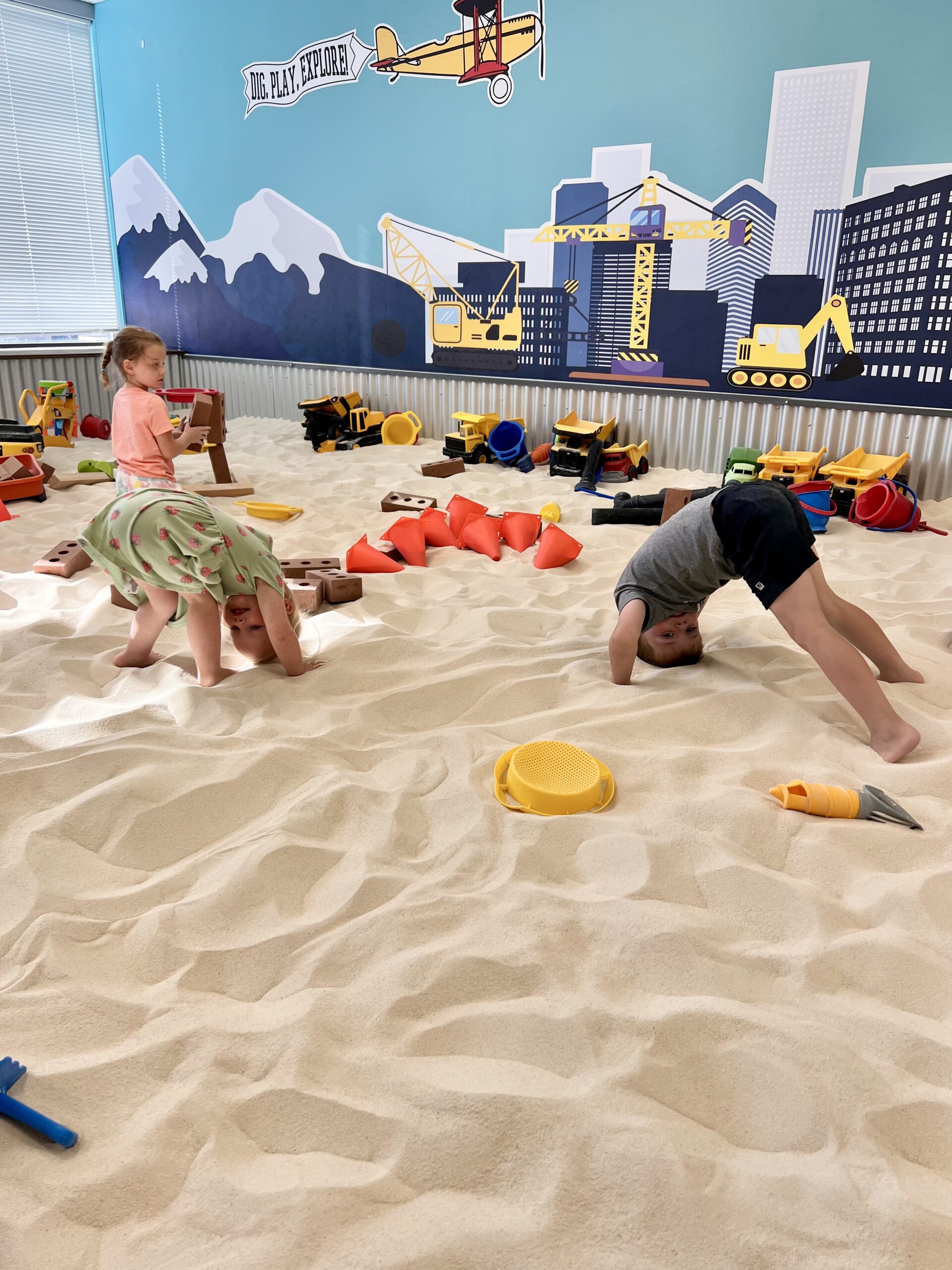 Kids playing with sand and water at indoor playground near Parker Colorado