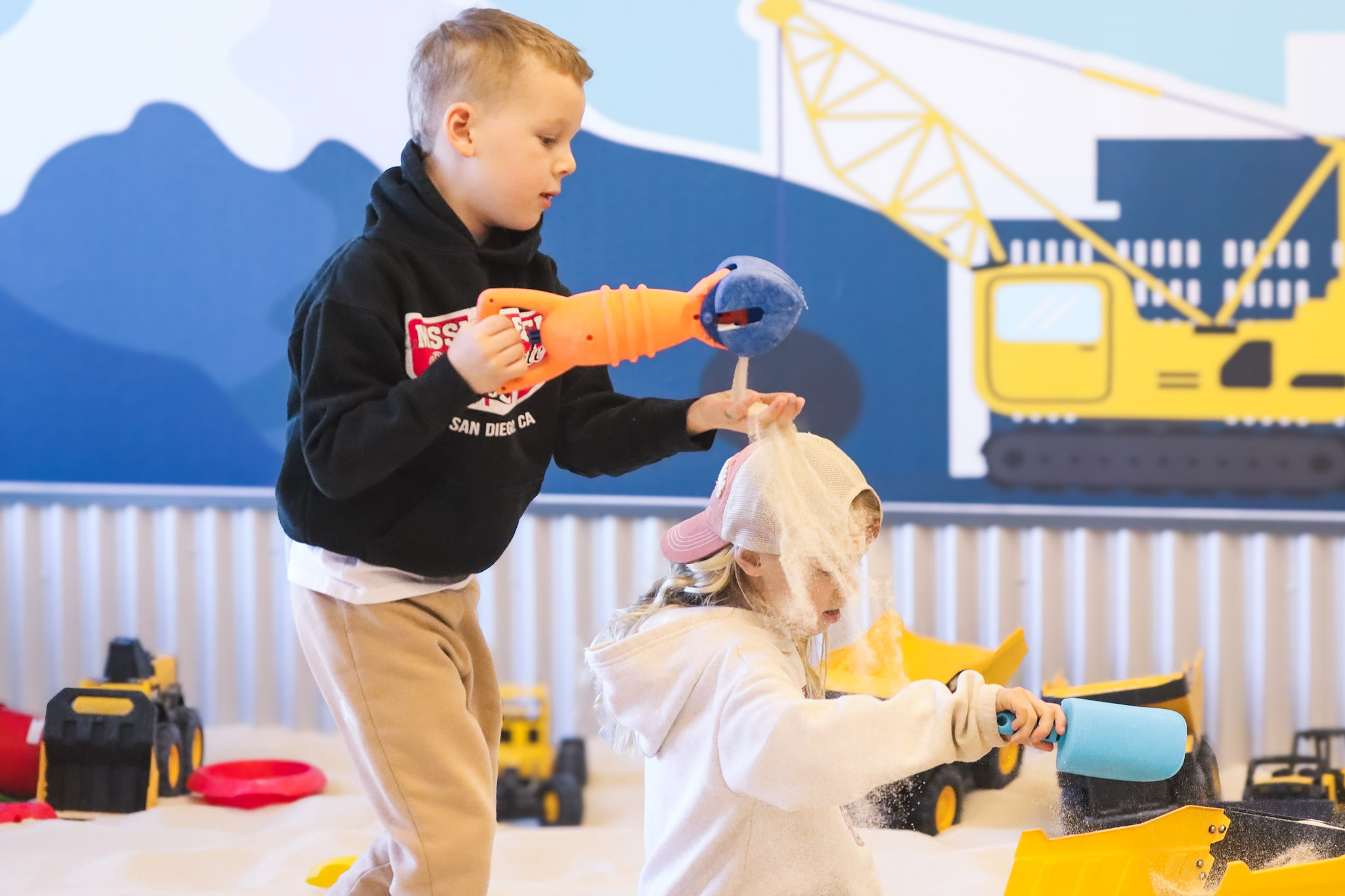 Group of young children playing in sand together at Aurora Colorado playground