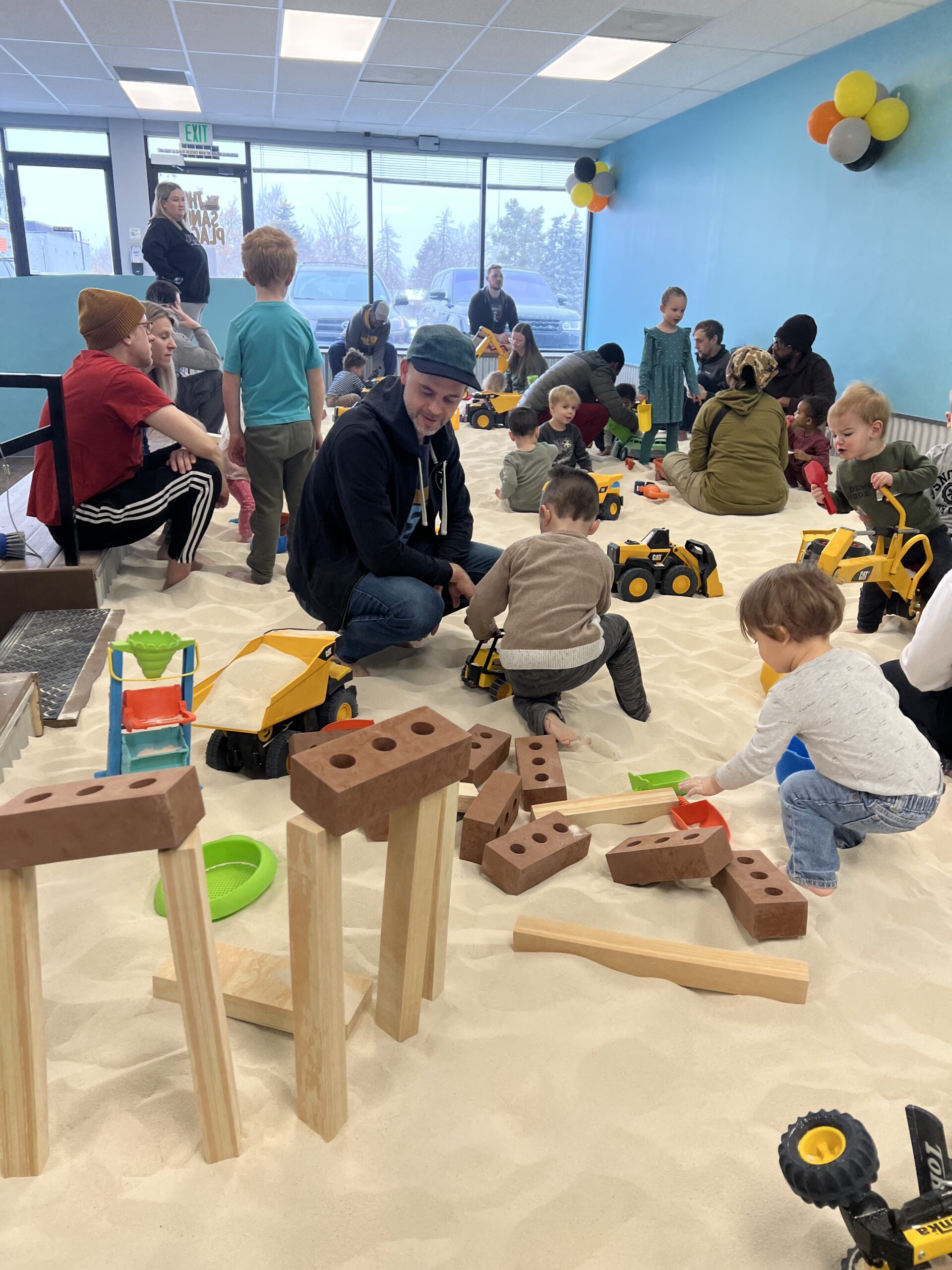 Kids playing happily at The Sand Place indoor sand playground Aurora Colorado