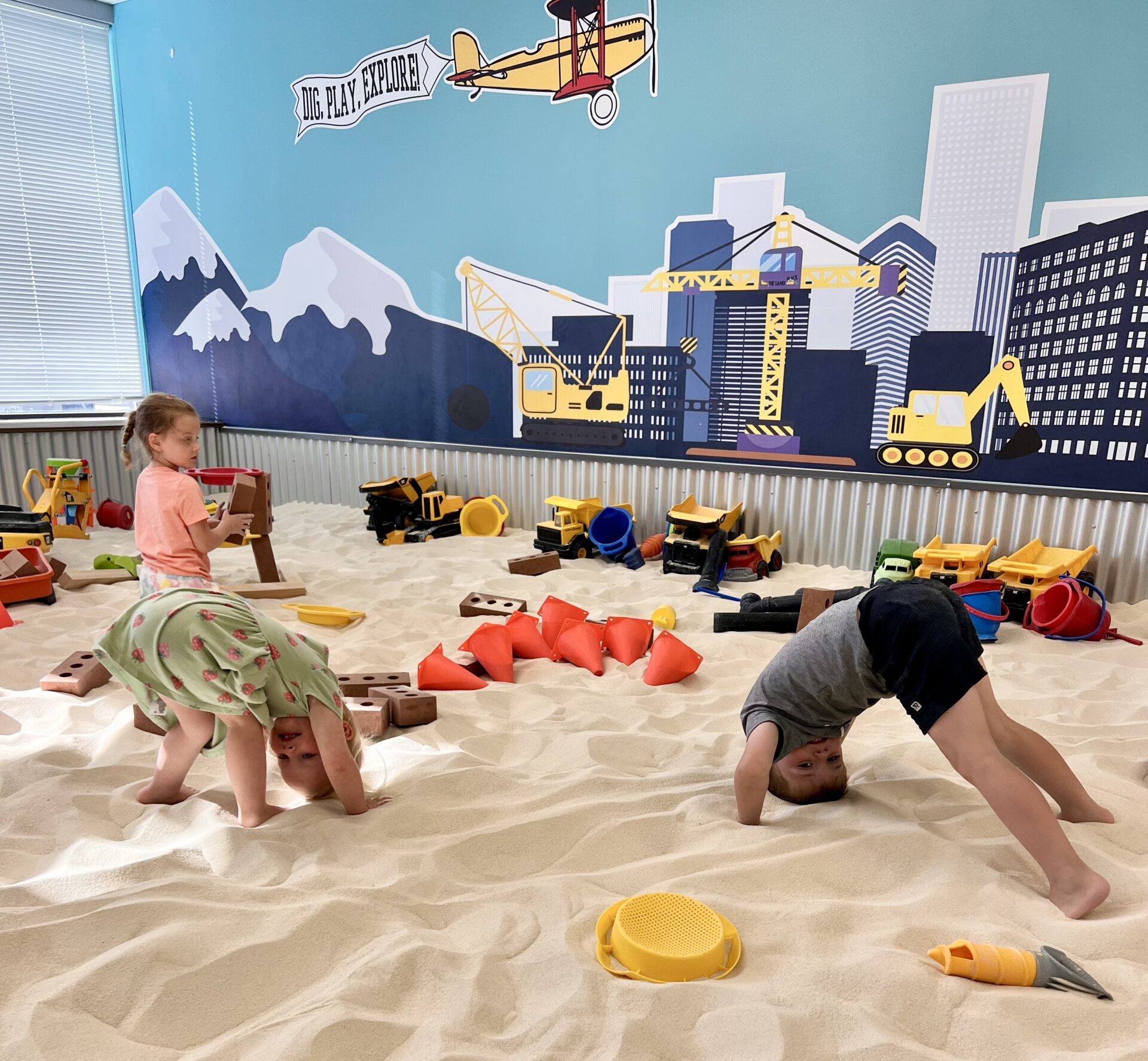 Students exploring the giant indoor sandbox at The Sand Place in Aurora, Colorado