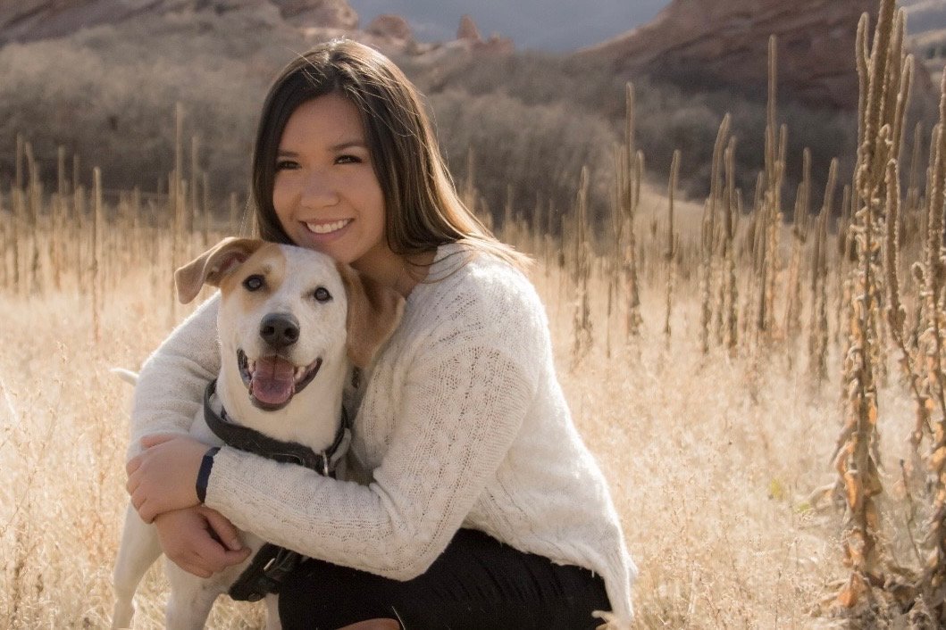 Melody, the new manager at The Sand Place in Aurora, Colorado, smiling outdoors with her dog